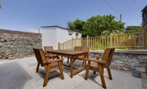 a patio garden with chairs and table